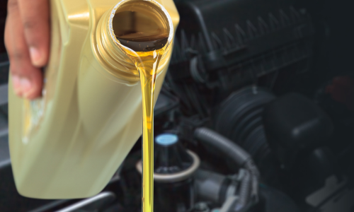 Motor oil being poured out of a bottle.